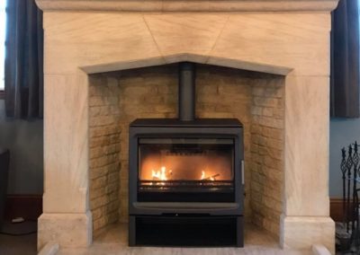 Fireplace Finesse Purevision PV85 stove with a logstore.